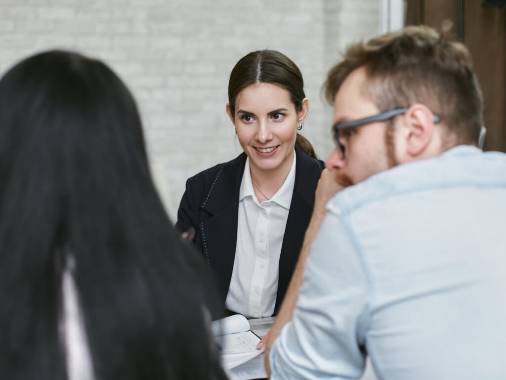 Professionals collaborating during a workplace meeting, demonstrating effective communication and career development.
